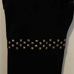 Black dress with gold small taps all around the waist line.